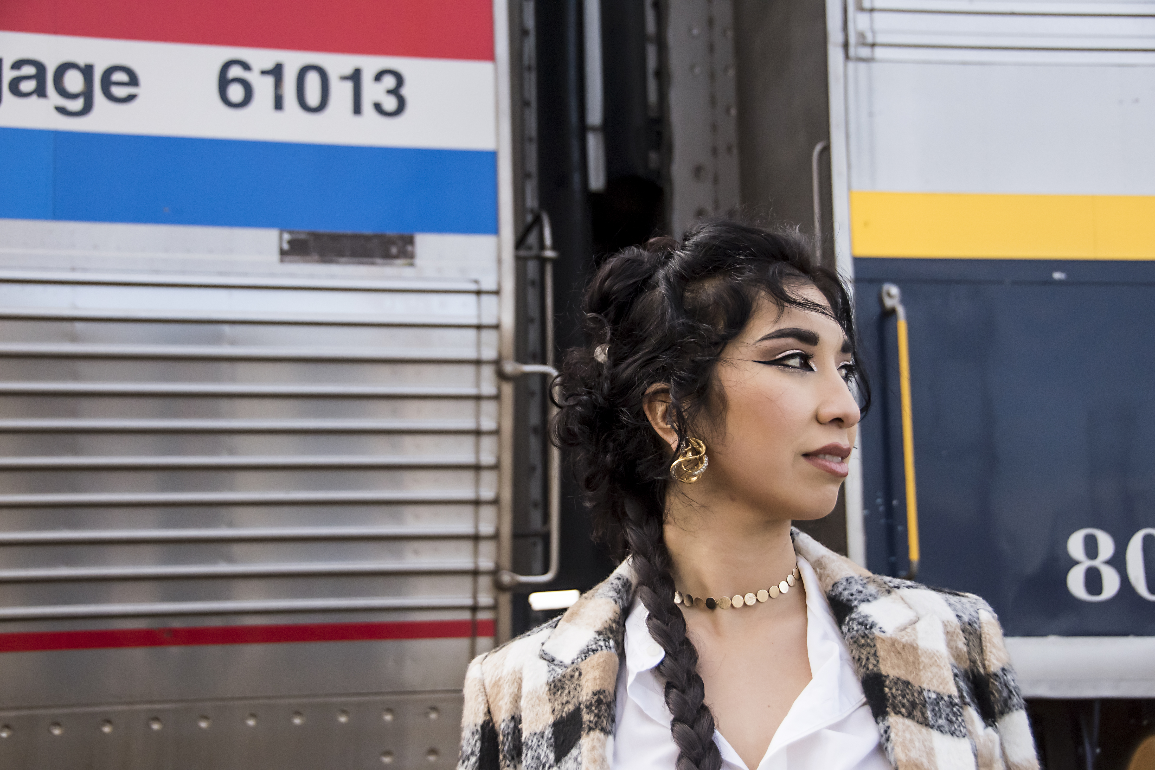 Portrait of Ruby Mountain in modern Afghan couture, blending music and culture.