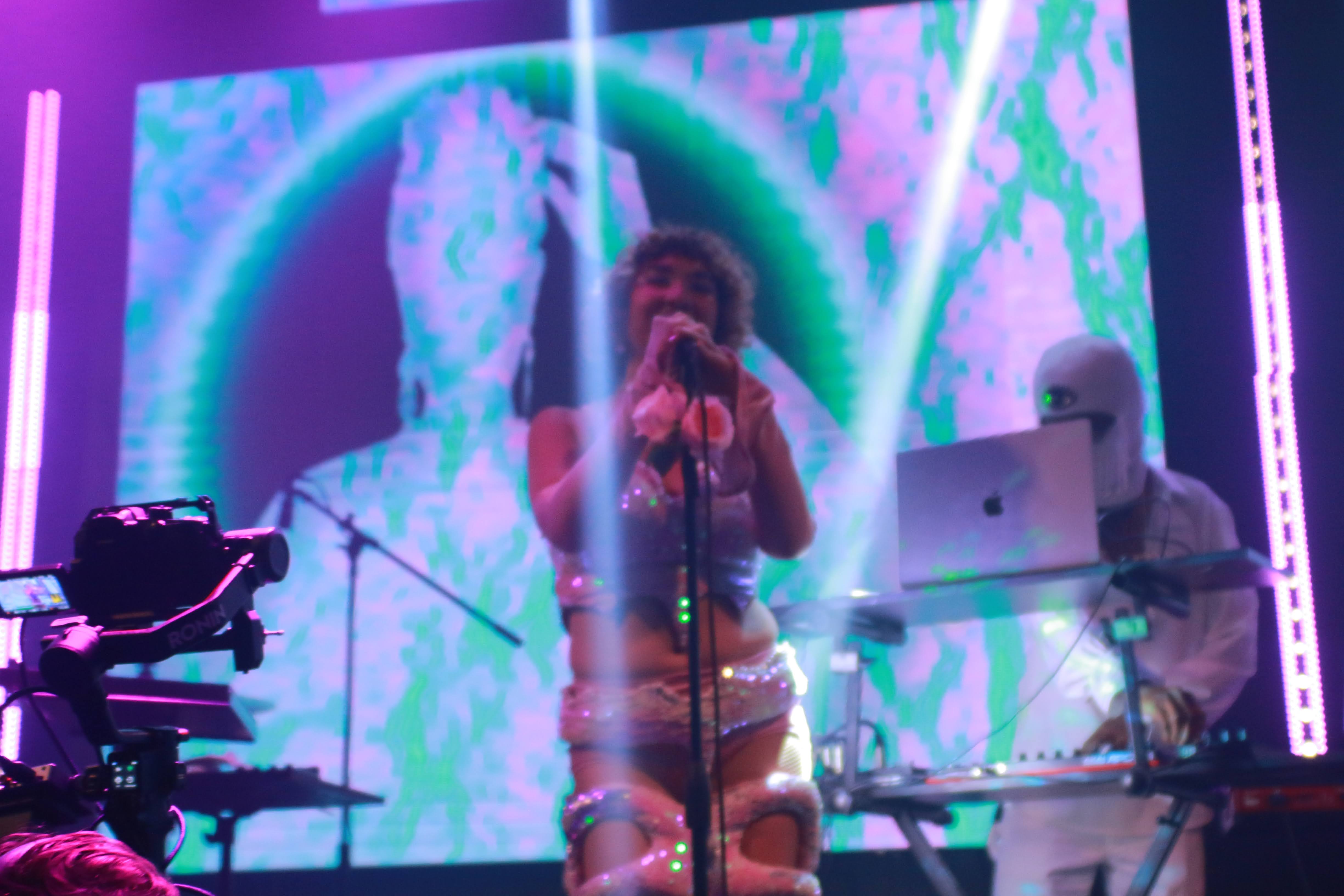 EDM artist and singer Ruby Mountain on stage in Hollywood, channeling otherworldly energy.